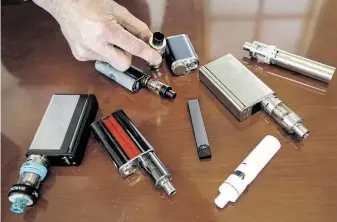  ?? Associated Press file photo ?? Vaping devices confiscate­d from high school students in Massachuse­tts are displayed. The rise of underage vaping has almost completely overshadow­ed a parallel drop in traditiona­l smoking.