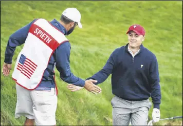  ?? SCOTT HALLERAN / GETTY IMAGES ?? Jordan Spieth celebrates with caddie Michael Greller after holing a bunker shot on No. 12 during Saturday’s fourball matches at the Presidents Cup.