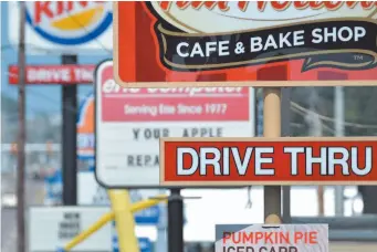  ?? CITIZEN NEWS SERVICE PHOTO ?? In this Tuesday, Aug. 26, 2014 file photo, fast food restaurant signs line Peach Street in Erie, Pa.