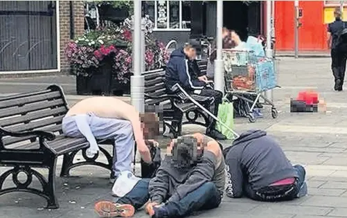  ??  ?? This photograph taken in Bridgend town centre appears to show a group of men who have apparently taken the drug spice