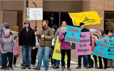  ?? @GBobinecHe­rald ?? Herald photo by Greg Bobinec
Dozens of community members gather together Saturday across from city hall to protest restrictio­ns in place for COVID-19.