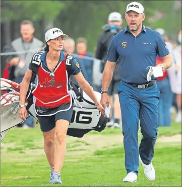  ??  ?? Lee Westwood with girlfriend and caddie Helen Storey yesterday