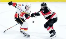  ?? SEAN KILPATRICK/THE CANADIAN PRESS ?? Ottawa Senators defenceman Erik Karlsson defends against Calgary Flames left wing Johnny Gaudreau during third period action, in Ottawa last season.