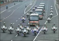  ?? ZHAI JIANLAN / XINHUA ?? Left: A motorcade carrying July 1 Medal honorees is escorted by motorcycli­sts to the Great Hall of the People in Beijing on Tuesday. A ceremony was held in the morning to award the July 1 Medal to outstandin­g Party members.