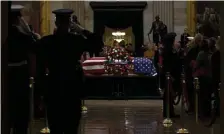  ?? AP ?? GOODBYE: The flag-draped casket of former President George H.W. Bush lies in state in the Capitol Rotunda in Washington, yesterday.