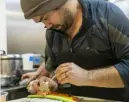  ?? ?? Benjamin B. Braun/Post-Gazette Simon Chough, chef and owner of Soju, prepares spicy tuna kimbap at his Garfield restaurant.