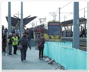  ?? MIKE HADDON. ?? A busy scene at Deansgate-Castlefiel­d during the evening rush hour on July 15 2015, as passengers board Tram 3068 for East Didsbury. With no public subsidy for Metrolink, passengers will face a 6% fare rise in January, passed on by TfGM to fund...