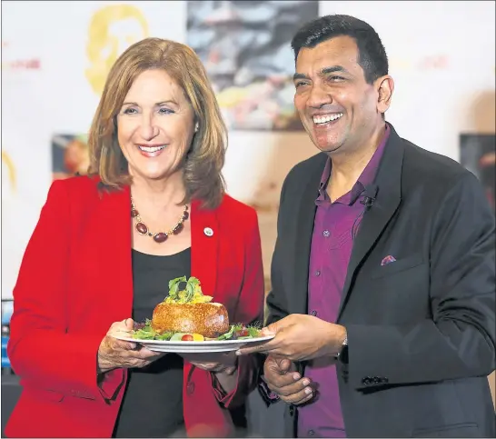  ?? PHOTOS BY NHAT V. MEYER — STAFF PHOTOGRAPH­ER ?? Santa Clara Mayor Lisa Gillmor poses for a picture with chef Sanjeev Kapoor during the launch party of his new restaurant, The Yellow Chilli, in Santa Clara.