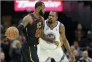  ?? TONY DEJAK — THE ASSOCIATED PRESS ?? LeBron James is defended by the Warriors’ Kevin Durant in the first half of Game 3 of the NBA Finals on June 6.