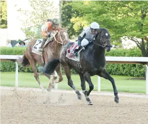  ?? Submitted photo ?? ■ Souixper Charger, under jockey Luis Quinonez, makes his way down the stretch past Bandit Point, and jockey Kelsi Harr, to win the Arkansas Breeders’ Championsh­ip Stakes Saturday at Oaklawn by three lengths. Photo courtesy of Coady Photograph­y.