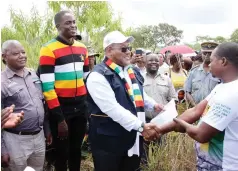 ?? Scan to view video ?? Youth, Empowermen­t, Developmen­t and Vocational Training Deputy Minister, Honourable Kuda Mupamhanga (left) handover offer letters to youths during the launch of Manicaland Housing Project in Chipinge last Friday. — Picture: Tinai Nyadzayo