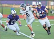  ??  ?? Coosa quarterbac­k Brevan Knight (center) runs the ball while being pursued by Darlington’s Cade Brock (left) and Tate Ratledge during Friday’s game .