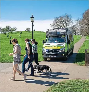  ?? REX ?? Watchful eye: Police in a van and on foot patrol London’s Primrose Hill on Sunday