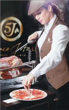  ?? PROVIDED TO CHINA DAILY ?? Beli Simeon, a senior ham carver, demonstrat­es proper slicing at a recent tasting event organized by a producer of Spanish ham, 5J Cinco Jotas.