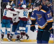  ?? (AP/Jeff Roberson) ?? Teammates congratula­te Colorado’s Darren Helm on his game-winning goal Friday as Niko Mikkola of St. Louis (right) skates off the ice after the Avalanche’s 3-2 win in St. Louis.