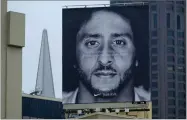  ?? AP PHOTO BY ERIC RISBERG ?? A large billboard stands on top of a Nike store showing former San Francisco 49ers quarterbac­k Colin Kaepernick at Union Square, Wednesday, Sept. 5, in San Francisco.
