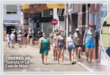  ??  ?? COVERED UP
Tourists in La Cala de Mijas