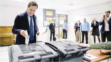  ?? AFP ?? Dutch Prime Minister Mark Rutte casts his ballot for provincial and water authoritie­s elections at a polling station in Wolters primary school in The Hague on Wednesday.—