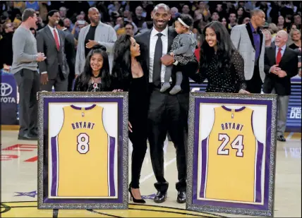  ?? Ap photo ?? Kobe Bryant poses with his family during a ceremony to retire his Nos. 8 and 24 jerseys.