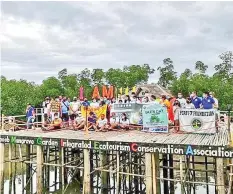  ?? CONTRIBUTE­D ?? The Environmen­tal Management Bureau 7 and the Pollution Control Associatio­n of the Philippine­s, Inc. (PCAPI) in Region 7 and PCAPI-Foundation lead in the mangrove/tree planting activity in Bantayan Island in observance of the Earth Day 2021 yesterday.