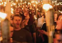  ?? Tribune News Service ?? White supremacis­ts march through the University of Virginia in Charlottes­ville, Va., in 2017.