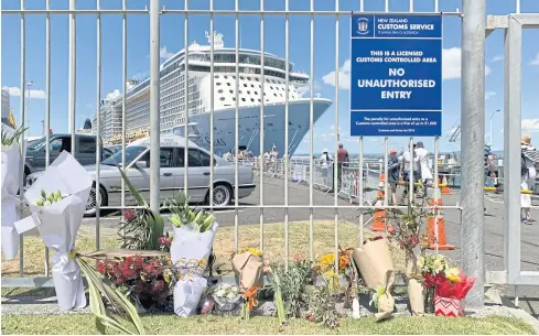  ?? AP ?? A makeshift memorial is seen in front of the cruise ship ‘Ovation of the Seas’ in Tauranga yesterday. Many of the victims were passengers of the ocean liner.