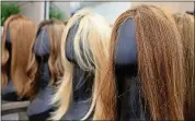  ??  ?? Natural hair wigs on display at Rebecca Walden Wig Studio in Sandy Springs on March 11.