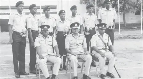  ??  ?? Seated from left: Assistant Commission­er of Police and Force Training Officer Paul Williams, Commission­er of Police Seelall Persaud and Assistant Superinten­dent of Police Bacchus pose with the most outstandin­g ranks for each recruit course yesterday.