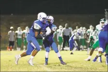  ?? PHOTO BY JERRY BALLENGEE ?? Lackey senior running back Malik Burns, left, receives the handoff from junior quarterbac­k Wesley Johnson in Friday night’s 35-6 win over the St. Charles Spartans in a SMAC nondivisio­n football contest. Burns finished with 256 yards on 20 carries and...