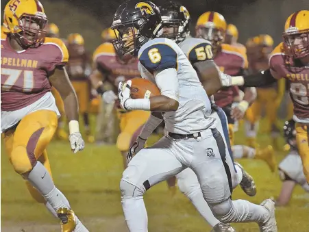  ?? STAFF PHOTO BY CHRIS CHRISTO ?? CAN’T SLOW THEM DOWN: Marlon Scott carries the ball past the Cardinal Spellman defense as St. Mary’s rolled to a 48-8 rout in a Catholic Central Large showdown last night; at right, Spellman’s J.J. Cooper tries to escape the grasp of Nino Echevarria of...