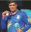  ?? Reuters ?? ■ Silver medalist Satish Kumar poses with his medal at the Men’s +91kg medal ceremony in Australia.