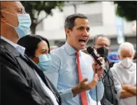  ??  ?? Flanked by party members, Venezuelan opposition leader Juan Guaido holds a news conference Monday in Caracas, Venezuela. (AP/Ariana Cubillos)