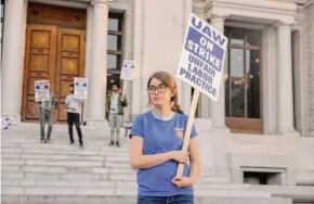  ?? Salgu Wissmath/The Chronicle ?? Postdoctor­al student Lexie McIsaac pickets at UC’s Hearst Mining Circle.