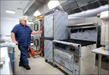  ?? NWA Democrat-Gazette/DAVID GOTTSCHALK ?? Barry Thomas, food service manager at the Fayettevil­le Senior Activity and Wellness Center, tours the new kitchen equipment at the center Wednesday. The center is undergoing a kitchen renovation to better serve its clients. The center has nearly 200...