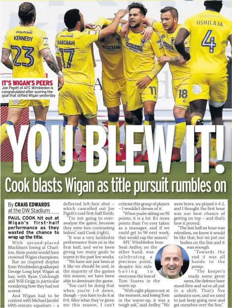  ??  ?? IT’S WIGAN’S PEERS Joe Pigott of AFC Wimbledon is congratula­ted after scoring the goal that stifled Wigan yesterday