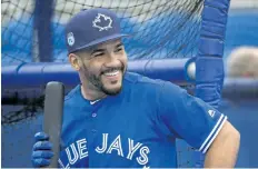  ?? NATHAN DENETTE/THE CANADIAN PRESS ?? Toronto Blue Jays second baseman Devon Travis smiles while taking part in batting practice during baseball spring training in Dunedin, Fla., last Thursday.