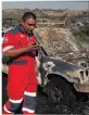  ??  ?? FIRE: Paramedic Mervin Ramsumar walks past a burned out municipal vehicle after checking the driver for any injuries.