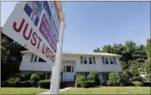  ?? AP FILE PHOTO ?? A for sale sign hangs in front of a house.