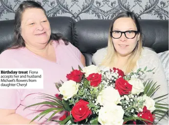  ?? ?? Birthday treat Fiona accepts her and husband Michael’s flowers from daughter Cheryl