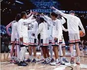  ?? ?? UConn huddles before the start of the second half of Sunday’s NCAA Tournament win over Northweste­rn at the Barclays Center in New York.