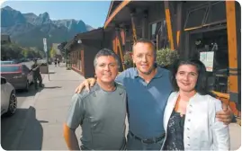  ?? CraigDouce/FortheCalg­aryHerald ?? Canmore business owners Michel Leblanc, of Rocky Mountain Flatbread Co., Mike Gordon, of Stonewater­s Home Elements and Jenn Butler of One Wellness + Spa on Canmore’s Main Street.