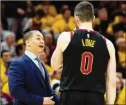  ?? JASON MILLER / GETTY IMAGES ?? Cavaliers coach Tyronn Lue and forward Kevin Love will try to keep the team competitiv­e without LeBron James, who left as a free agent.