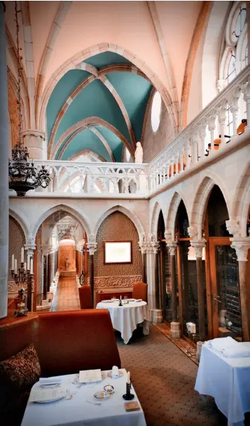  ??  ?? The restaurant at Abbaye de la Bussière, a hotel in a 12th-century abbey.