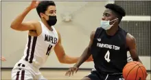  ?? DAN FENNER — FOR MEDIANEWS GROUP ?? Farmington’s Robert Davis, right, surveys the offensive end of the floor as he’s guarded by Seaholm’s Michael May in Tuesday’s Division 1 district-opening game. Seaholm prevailed on a last-second shot.