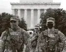  ?? Joe Raedle / Getty Images ?? National Guard members are stationed Tuesday outside the Lincoln Memorial before the inaugurati­on.