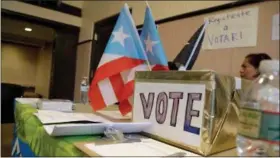  ?? JULIO CORTEZ — THE ASSOCIATED PRESS ?? A voter registrati­on booth stands during an event to help Puerto Rico hurricane victims in Elizabeth, New Jersey.