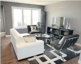  ??  ?? The main level of the showhome features caramel hardwood floors and an open concept
with great room.