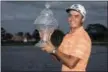  ?? MICHAEL ARES — THE PALM BEACH POST VIA AP ?? Rickie Fowler holds up the Honda Classic trophy after the conclusion of the golf tournament in Palm Beach Gardens, Fla., on Sunday.