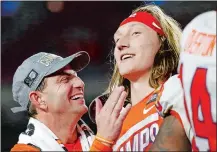  ?? ROSS D. FRANKLIN/AP PHOTO ?? Clemson coach Dabo Swinney celebrates with quarterbac­k Trevor Lawrence after Clemson defeated Ohio State 29-23 in the Fiesta Bowl on Saturday at Glendale, Ariz.