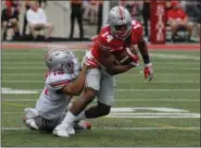  ?? ASSOCIATED PRESS FILE ?? Wide receiver K.J. Hill is tackled by linebacker Keandre Jones during the Ohio State spring game in Columbus.